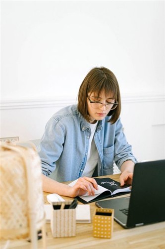 Modern Blog Founder 2026 Working At Desk With Laptop And Notes