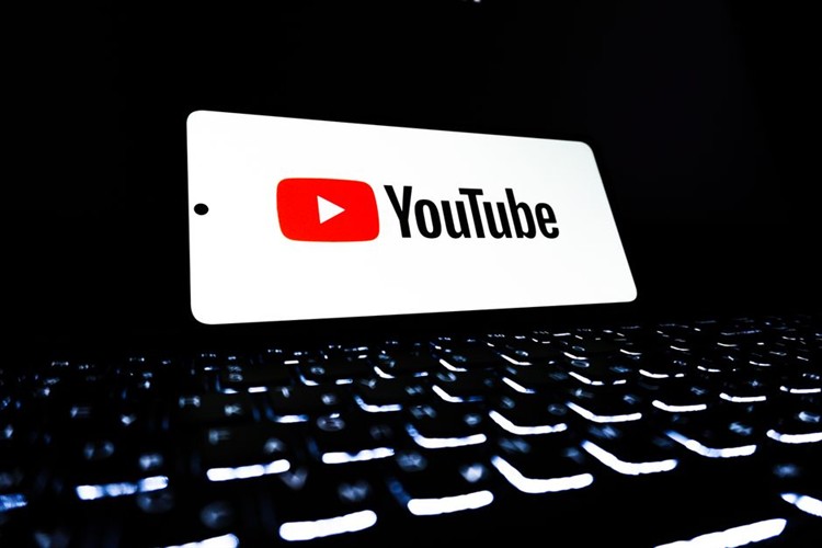 YouTube interface on screen displaying content creator page and video manager dashboard
