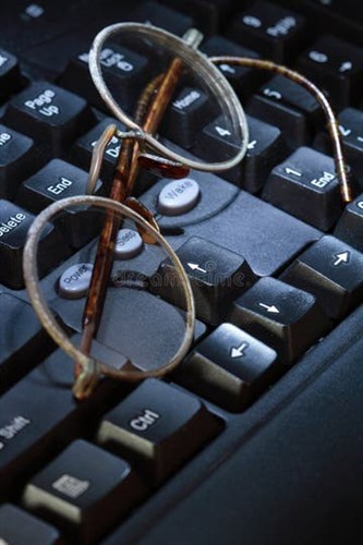 Developer computer keyboard with glasses on top